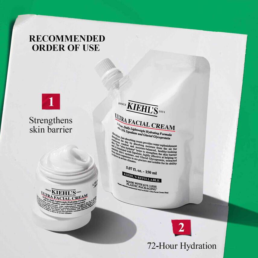 A deep burgundy Kiehl’s Advent Calendar box is featured closed against a matching textured background. The gold foil text on thebox reads “SHARING JOY SINCE 1851" with “ADVENT CALENDAR" at the bottom. A bright pink graffiti-style bow is illustrated above the box,and a pink banner in the top right corner reads: “24 days of GIFTING AWAITS!"