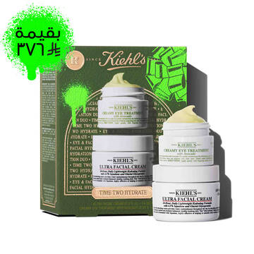 A Kiehl's green gift box is shown on the left, with "TIME TWO HYDRATE" text, and green graphic elements. To the right, two jars of products are stacked: the top jar is "KIEHL'S CREAMY EYE TREATMENT with avocado" and has a visible yellow-green swirl of product on top. The bottom jar is "KIEHL'S ULTRA FACIAL CREAM".