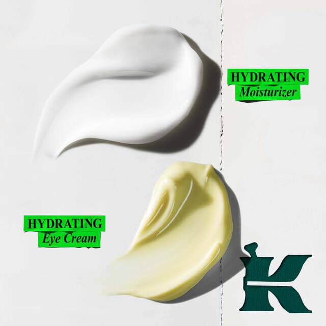 A graphic showing two swatches of cream on a white background. The top swatch is white, with green text to its right reading "HYDRATING Moisturizer". The bottom swatch is yellow-green, with green text to its left reading "HYDRATING Eye Cream". A large dark green "K" logo is in the bottom right corner.