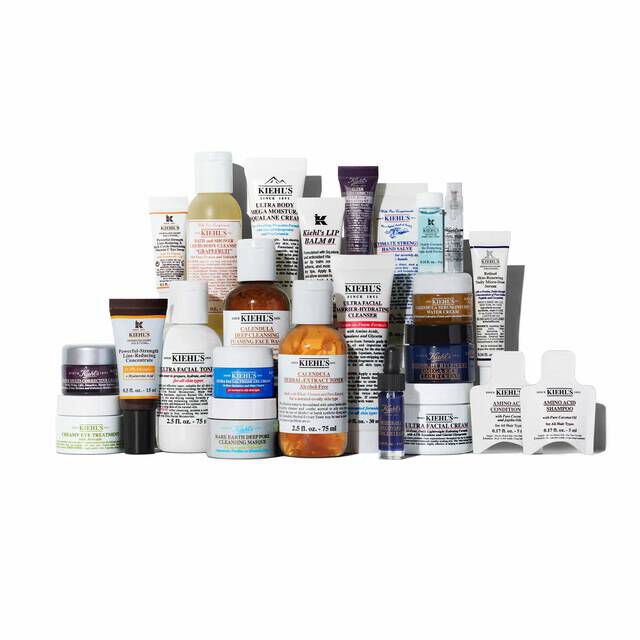 A lineup of 24 Kiehl’s mini skincare and body care products, including popular formulas like Ultra Facial Cream, Calendula Toner, and Midnight Recovery Concentrate, arranged against a white background.