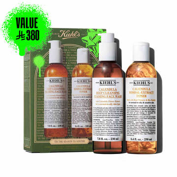 A graphic featuring a green and gold Kiehl’s gift box with two bottles in front: "KIEHL'S CALENDULA DEEP CLEANSING FOAMING FACE WASH" and "KIEHL'S CALENDULA HERBAL-EXTRACT TONER." The box is decorated with bright green accents and the phrase "TIS THE SEASON TO SOOTHE" at the bottom.